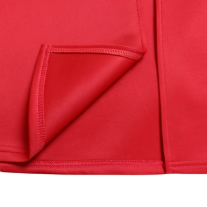 Close-up of fine stitching and hem detail on a vibrant red formal evening maxi dress