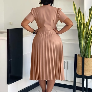 Rear view of an elegant pleated apricot midi dress with puff sleeves and cinched waistline