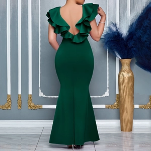 Rear view of deep green V-neck evening gown showing elegant ruffles and fishtail hem
