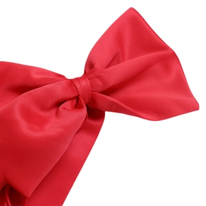 Detail of a vibrant red satin bow with silky texture and elegant glossy finish
