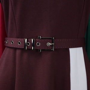 Detail of waist belt with silver metal eyelets on burgundy and white patchwork dress
