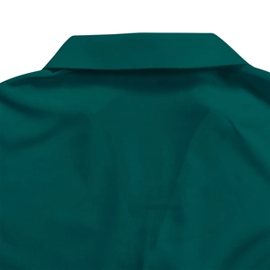 Detail of the elegant dark green pleated dress featuring a classic V-neckline and collar