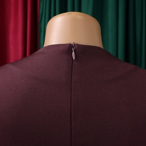 Close-up of the concealed invisible zipper on back neckline of dark purple dress
