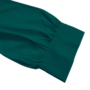 Detail of elegant emerald green pleated sleeve with wide cuffs on long maxi dress