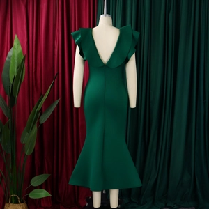 Detail of dark green fisheye dress showing back V-cut and ruffled sleeve texture