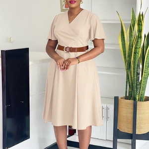 Detail of beige V-neck wrap dress with ruffle sleeves and brown buckled leather belt