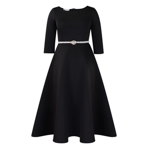 Detail view of the black evening dress showing pearl rhinestone belt and three-quarter sleeves