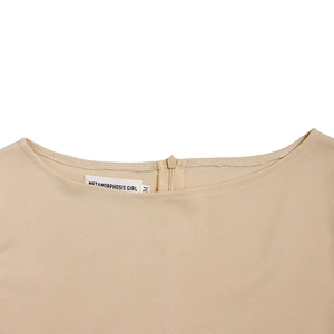 Detailed view of beige dress neckline featuring round collar and branded size tag
