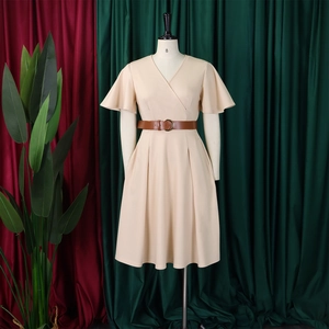 Detail of V-neck wrap dress with butterfly sleeves and round buckle belt on mannequin