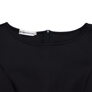 Detail of round neckline with invisible zipper and brand label on a black evening gown