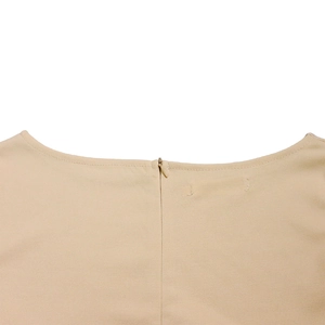 Close-up of invisible zipper and neat stitching on beige fashion dress neckline