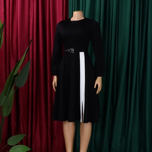 Detail of black long sleeve maxi dress with white vertical stripe and waist belt