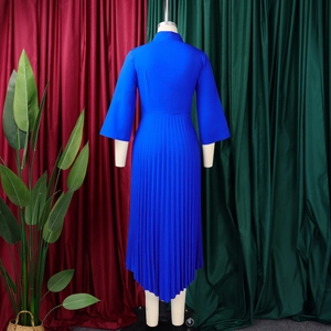 Detail of royal blue pleated dress featuring an asymmetrical hem and elegant high waist