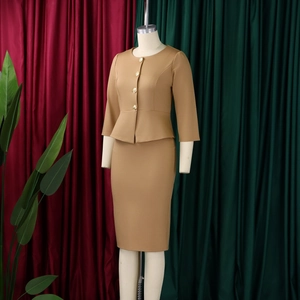 Detail of camel two-piece skirt set with ruffle hem jacket and golden buttons
