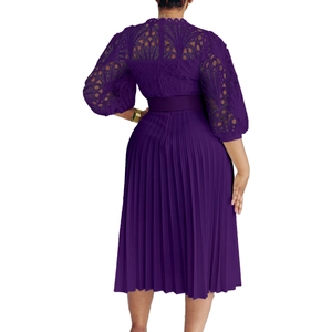 Rear view showing detailed lace crochet and pleated hem of the dark purple dress