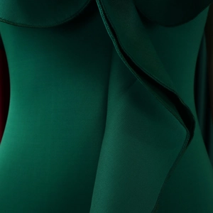 Detailed close-up of dark green ruffled hem with premium fabric texture and clean stitching