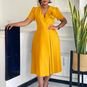 Detail of elegant yellow V-neck dress featuring 3D floral accent and pleated skirt side