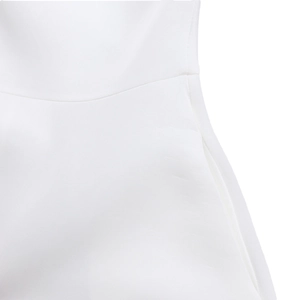 Detailed view of the high-waist stitching and pocket seam on a white evening dress