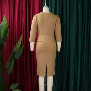 Detail view of khaki two-piece skirt suit back featuring peplum waist and slit hemline