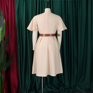 Back view of apricot A-line dress with ruffle sleeves and a dark brown waist belt