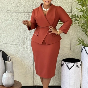 Detail view of brick red two-piece business suit featuring double-breasted blazer and midi skirt