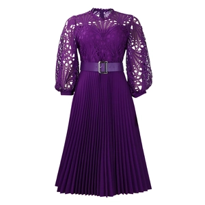 Detail of dark purple dress with delicate lace top, lantern sleeves, and pleated skirt