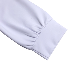 Close-up of white long sleeve dress with compact ribbed cuffs and neat pleat details