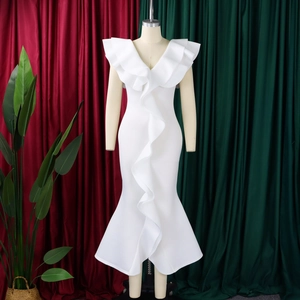 Detail of white V-neck evening gown featuring elegant cascading ruffles and fishtail hem