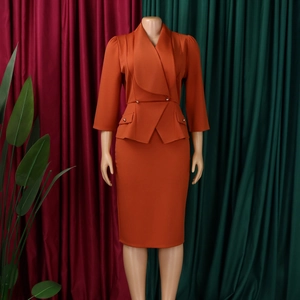 Detail of bright orange blazer with ruffle hem and matching midi bodycon skirt set