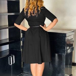 Back view detail of a black A-line plus size dress featuring mid-length sleeves and slim waist