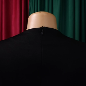 Detail view of high waist black dress showing back invisible zipper and neckline