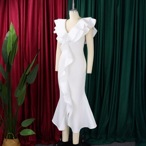 Detail view of white V-neck evening gown featuring elegant ruffled tiers and fishtail hem
