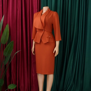 Detail of elegant caramel professional two-piece suit with peplum waist and pencil skirt