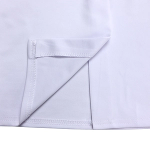 Detailed close-up of the white dress hem showing the fine stitching and side slit design