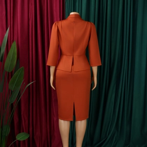 Back view of rust red slim-fit midi pencil skirt with middle slit and back zipper closure
