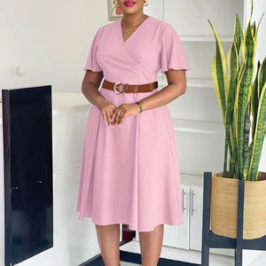 Detail of elegant V-neck pink dress with ruffle sleeves and brown metallic buckle belt