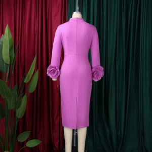 Detailed view of elegant 3D floral fold embellishments on the cuffs of the mauve dress