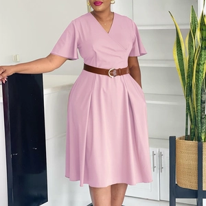 Detail of elegant pink V-neck dress with flared sleeves and a stylish brown leather waist belt
