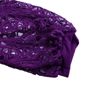 Detailed view of dark purple lace hollow embroidery and pleated fabric on the sleeve