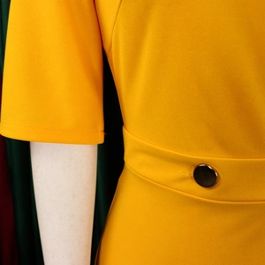Close-up of bright yellow V-neck dress featuring a waist belt with dark metal button detail