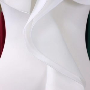 Macro shot of tiered white ruffle details and fine stitching on the elegant dress fabric