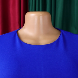 Close-up detail of the elegant crew neck and textured knit fabric in royal blue