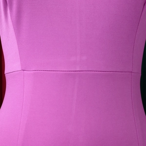 Macro shot of the waist seam and textured purple fabric of the elegant OL dress