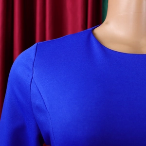 Detailed view of royal blue round neck design and stitching on elegant knit dress