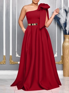 Elegant burgundy one-shoulder evening maxi dress with large bow detail and gold belt
