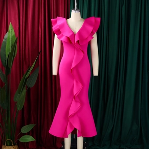 Detailed view of the deep V-neckline with layered ruffles on a rose red evening dress