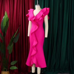 Detail of ruffled cascade and asymmetrical fishtail hem on rose pink V-neck evening gown