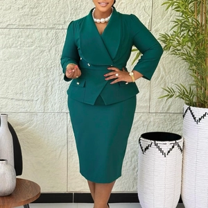 Detail view of dark green two-piece skirt suit with golden buttons and slim fit blazer