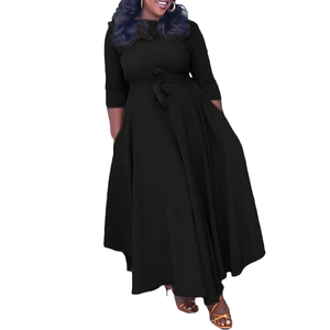 Detail view of waist tie design on a stylish black long-sleeved dress with a full skirt
