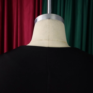 Detail view of the back neck and smooth stitching on this elegant black African outfit